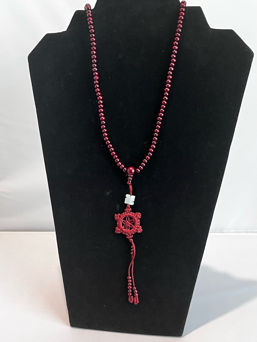 Long Wooden Beaded Necklace with Knotted Floral Pendant & Green Stone Accent